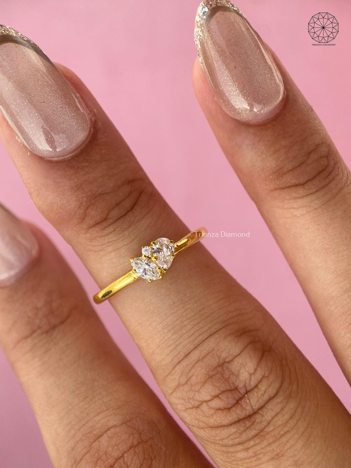 Close-up of the marquise cut lab grown diamond paired with a pear shaped stone in yellow gold