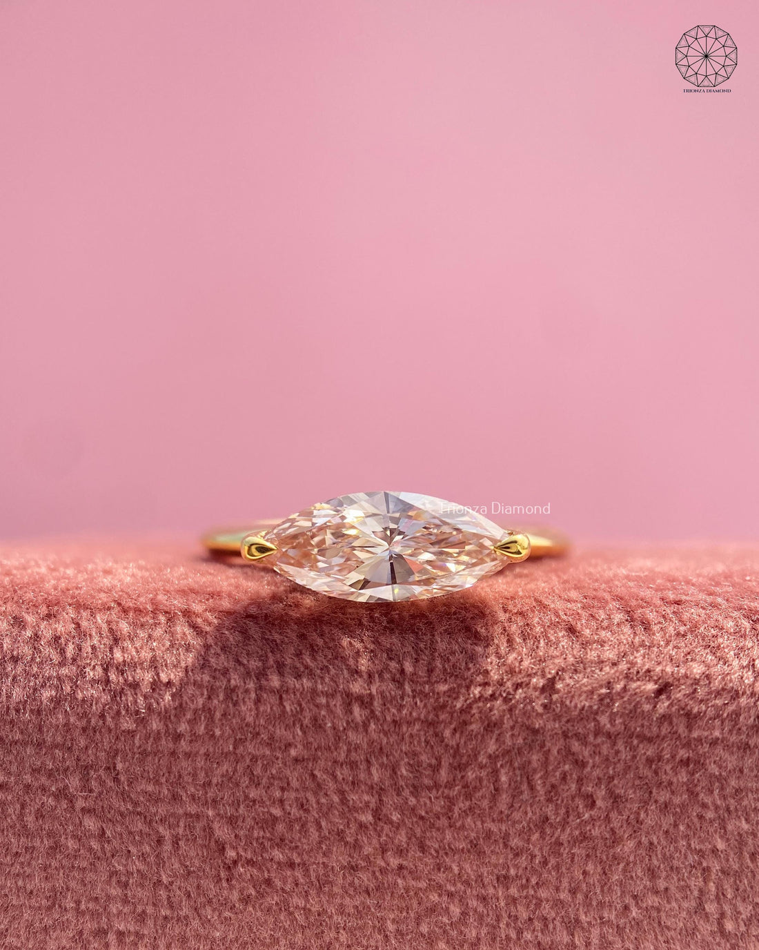 East west marquise lab grown diamond ring displayed in yellow gold with a slim band