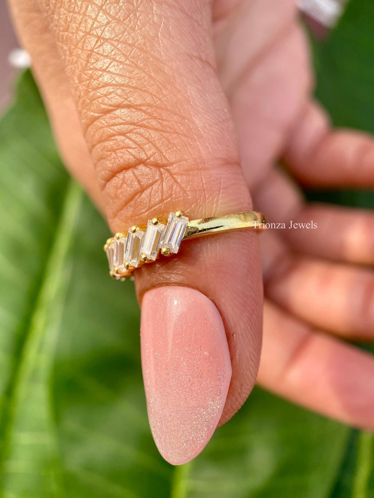 Stackable anniversary band shown alongside complementary rings for a layered look