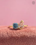 Toi et moi ring featuring a blue Asscher cut and pink pear cut lab grown diamond in yellow gold