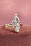 Woman wearing the marquise cut solitaire ring, showcasing its elongated silhouette