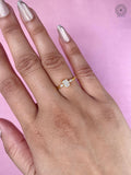 Yellow gold minimalist ring displaying a modern classic three stone design