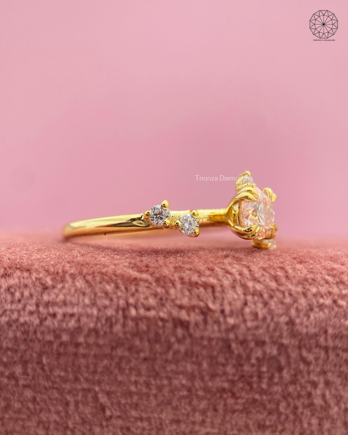 Close-up of the petal cluster shoulder accents surrounding the round brilliant diamond