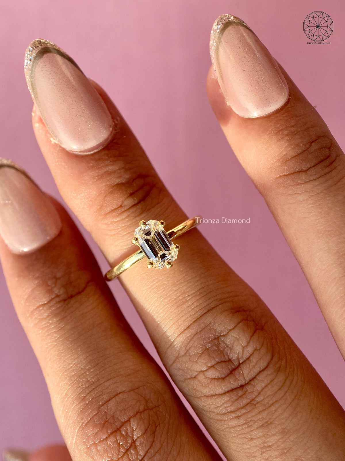 Side profile of the yellow gold solitaire ring showing the step cut diamond details
