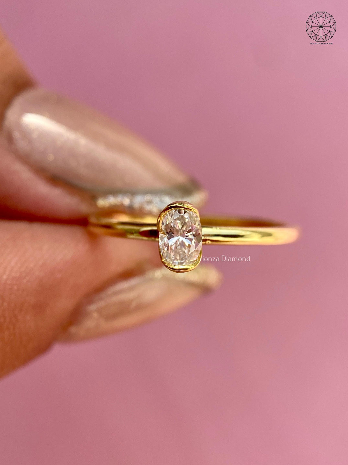 Side view of the oval diamond ring highlighting its sleek bezel profile