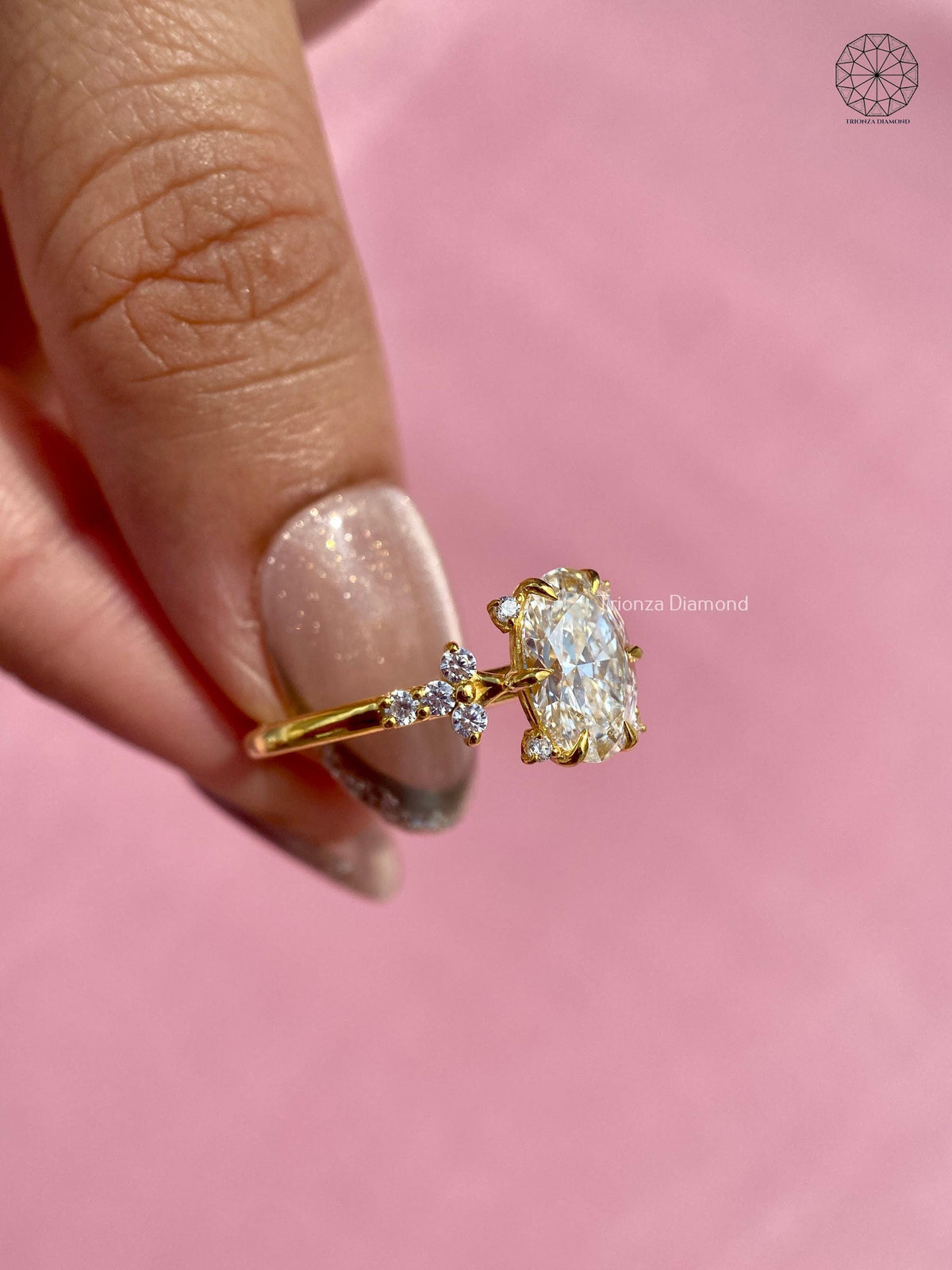 Side view of the oval cut diamond ring highlighting the prong set cluster design
