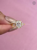 Woman wearing the oval diamond cluster ring, close-up view of her hand