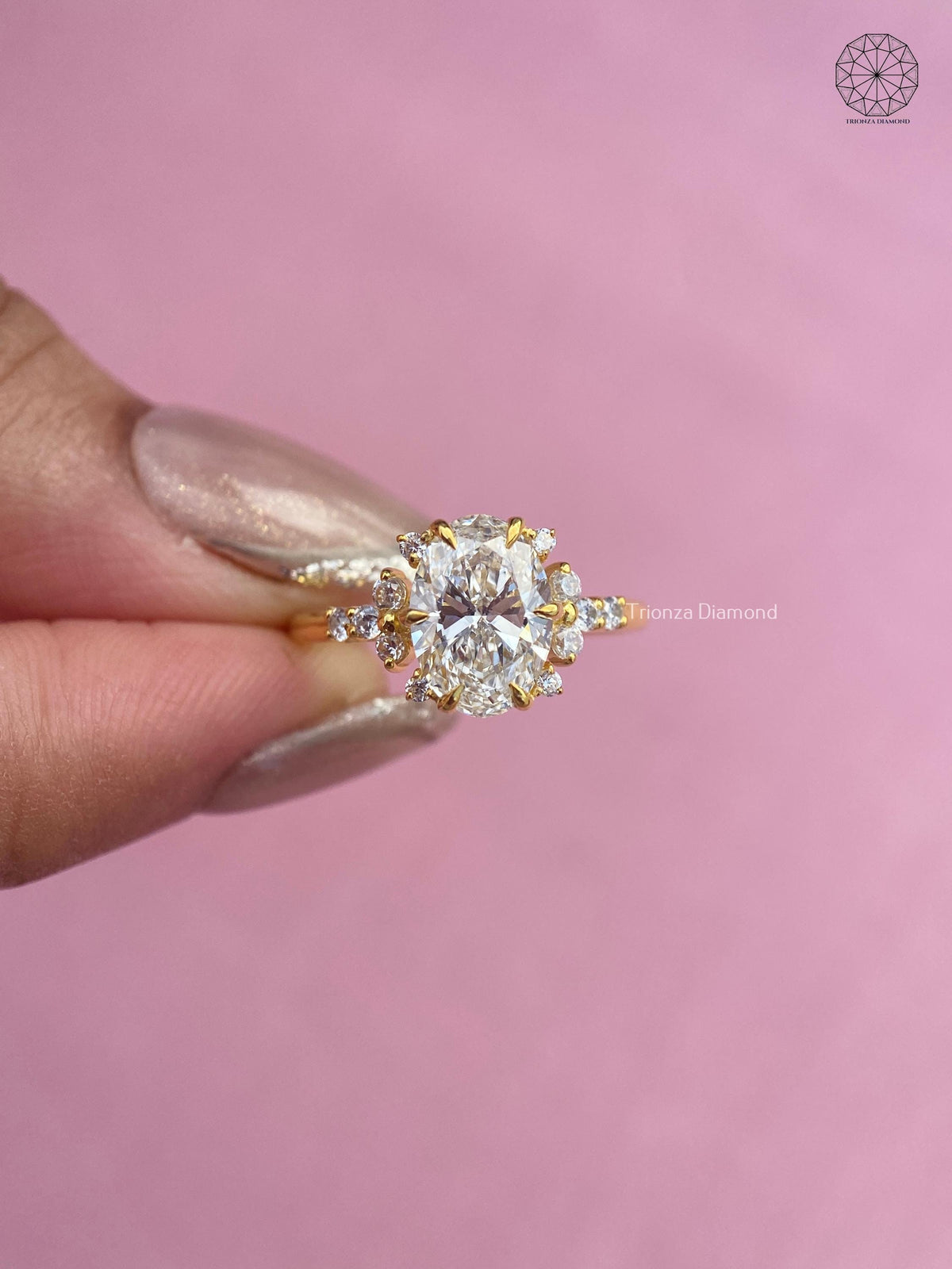 Woman wearing the oval diamond cluster ring, close-up view of her hand
