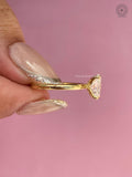 Woman wearing the oval diamond engagement ring, close-up on her hand