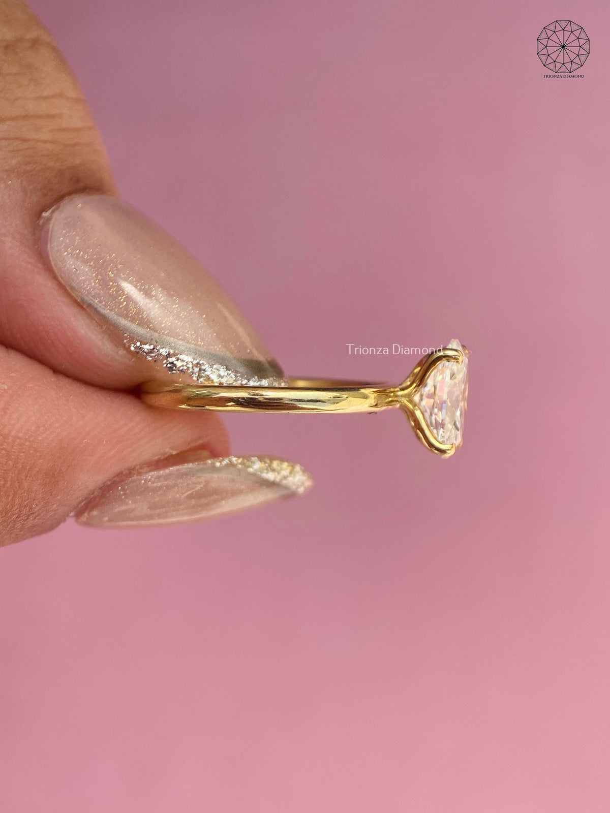 Woman wearing the oval diamond engagement ring, close-up on her hand