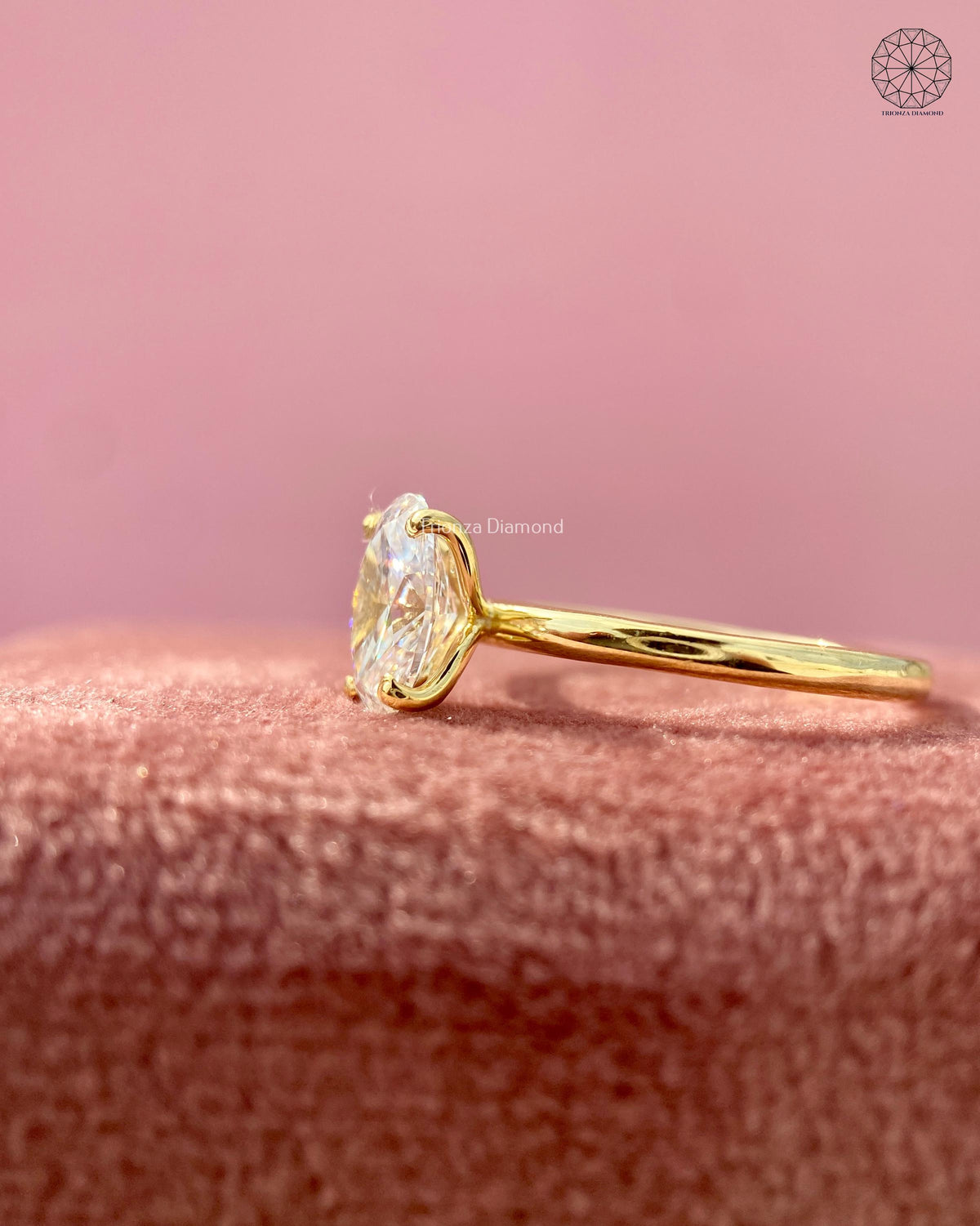 Close-up of the four prong raised head setting securing the oval lab grown diamond