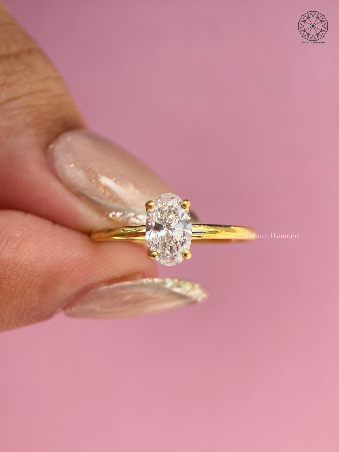 Oval lab grown diamond solitaire ring in 14K yellow gold with a four claw prong setting