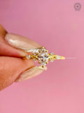 Woman wearing the yellow gold marquise diamond ring with floral cluster details