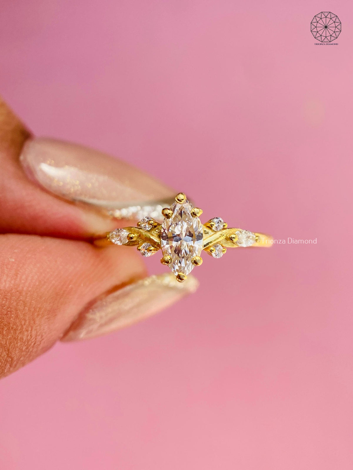 Woman wearing the yellow gold marquise diamond ring with floral cluster details