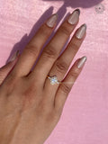 Handmade floral halo ring featuring lab grown marquise diamonds in yellow gold