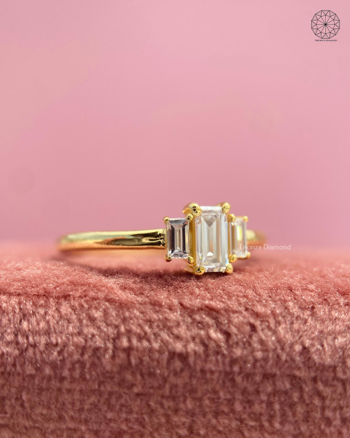Emerald cut three stone ring displayed to highlight its geometric and architectural styling