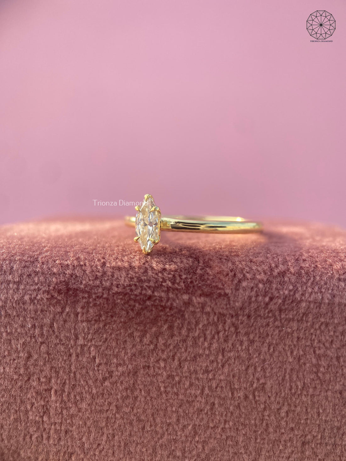 Marquise lab grown diamond engagement ring featuring a six prong raised solitaire setting