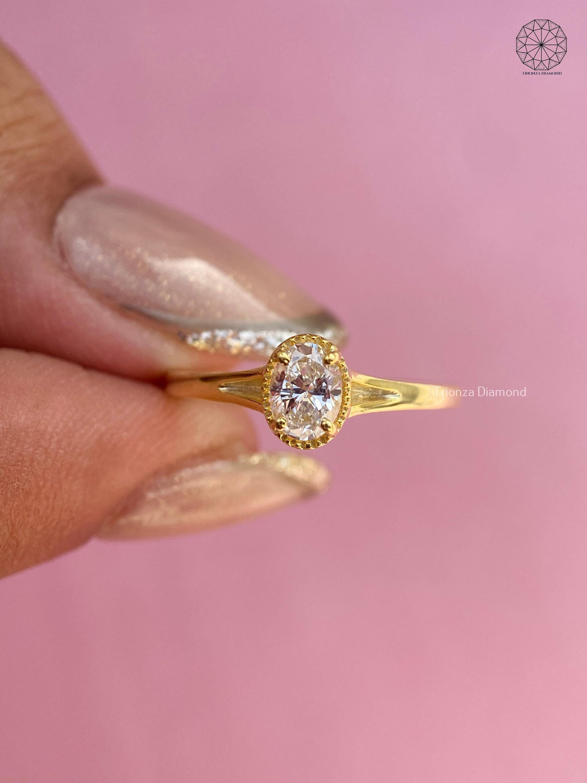 TrionzaDiamond engagement ring featuring an oval brilliant diamond in yellow gold