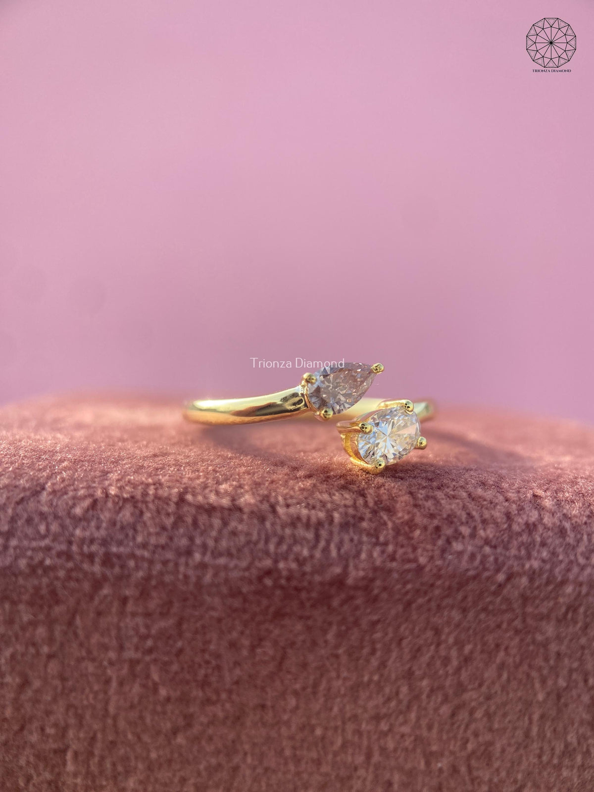Open cuff band showcasing the asymmetrical round and pear diamond arrangement