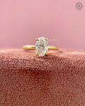 Oval brilliant solitaire engagement ring in 18K yellow gold with a split shank design