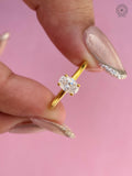 Oval cut lab grown diamond engagement ring showcasing a polished yellow gold solitaire band