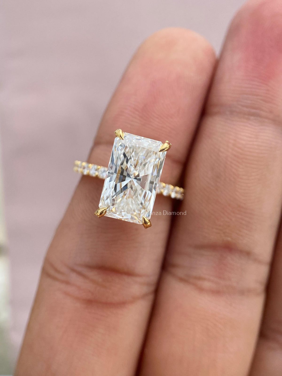 Side view of the radiant cut diamond ring highlighting the hidden halo setting details