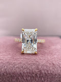 Radiant cut lab grown diamond engagement ring featuring a hidden halo and side round diamonds