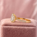Pave engagement ring displayed in a jewelry box alongside its smooth fabric lining