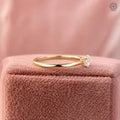 Woman wearing the solitaire engagement ring, showcasing its dainty gold band design