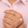 Close-up of the E/F VVS2 certified diamond band showing continuous round cut sparkle