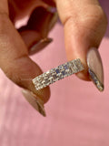 Baguette and round cut lab grown diamond half eternity band displayed in a ring box