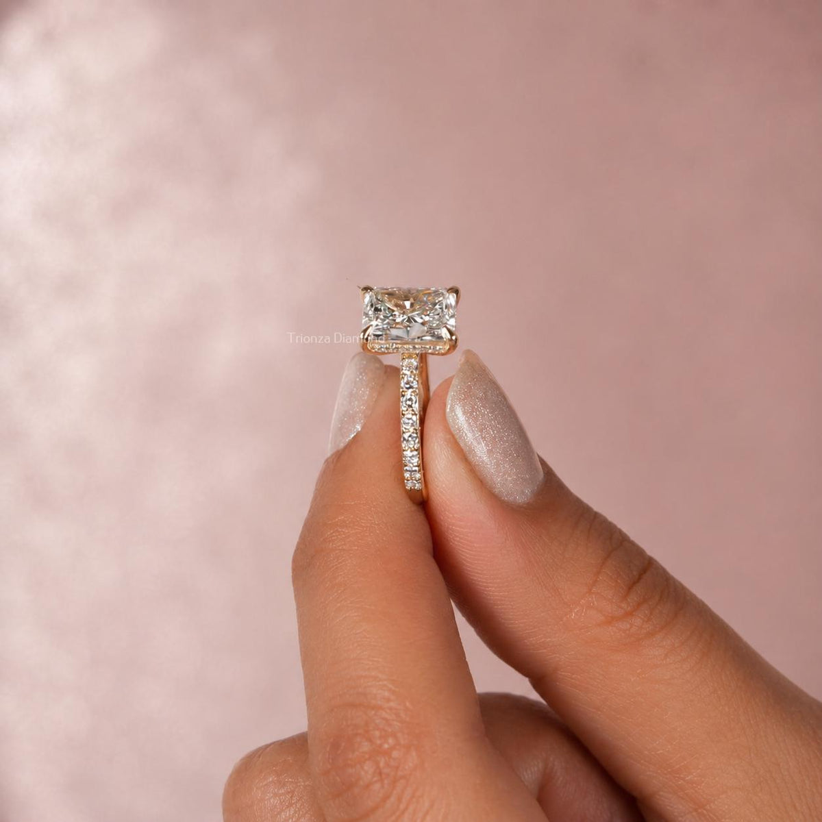 Radiant cut diamond wedding ring shown from a side angle highlighting the invisible halo pave band
