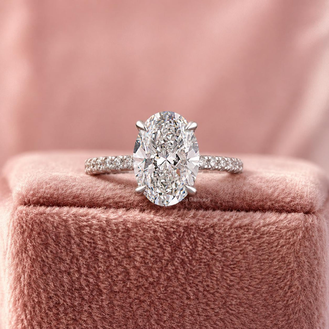 Oval cut lab grown diamond engagement ring featuring a hidden halo and pavé band design