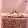 Close-up of the curved chevron band highlighting the pear diamond centered among round accents