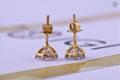 Pair of round cut diamond solitaire studs photographed in natural sunlight