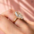 Hidden halo ring showcasing round cut accent diamonds beneath the marquise center stone