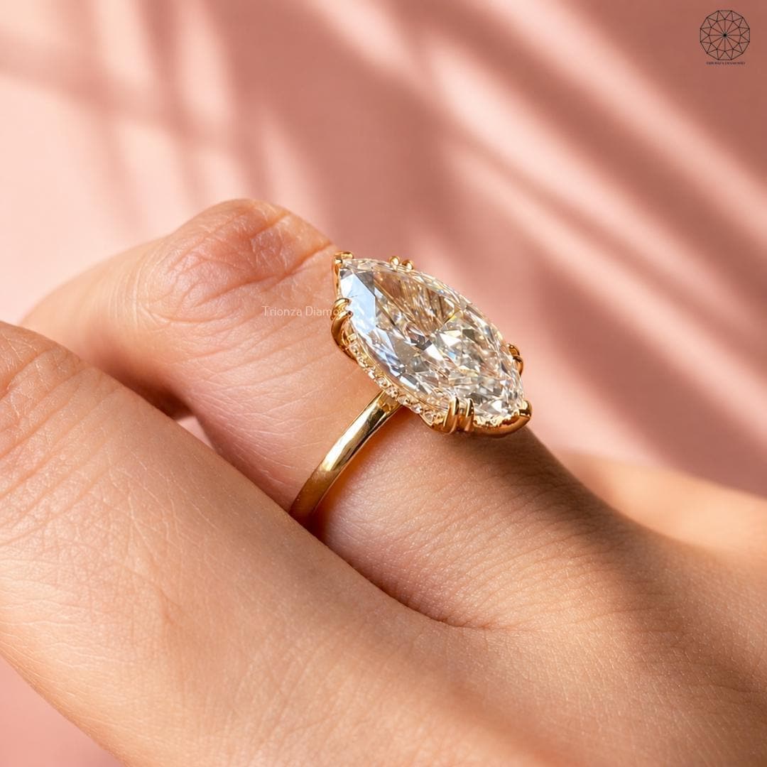 Hidden halo ring showcasing round cut accent diamonds beneath the marquise center stone