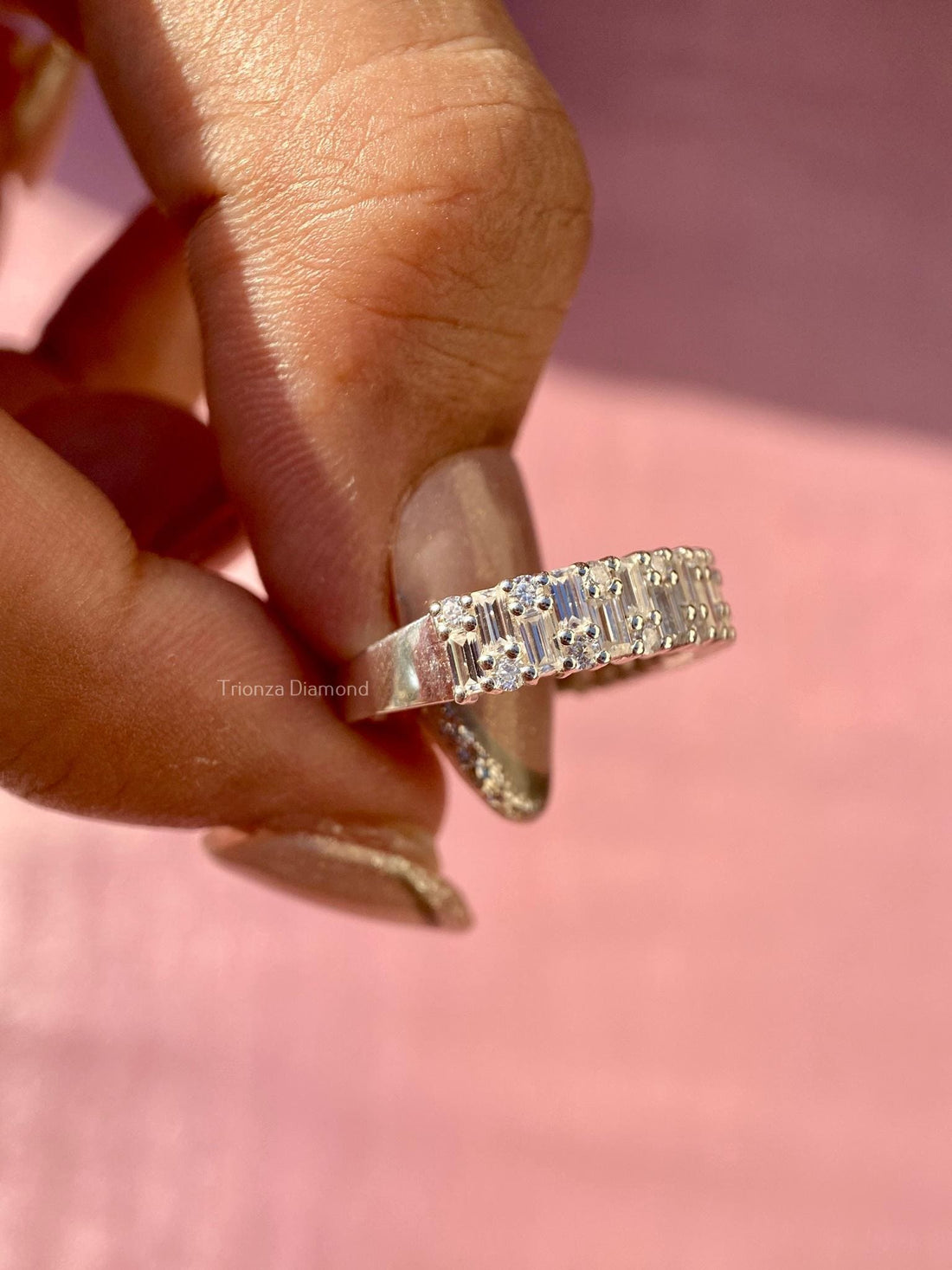 Baguette and round cut lab grown diamond half eternity band displayed in a ring box