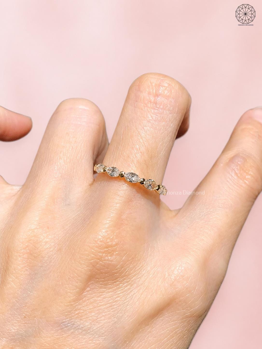 Close-up of the marquise cut diamonds set along the half eternity wedding band