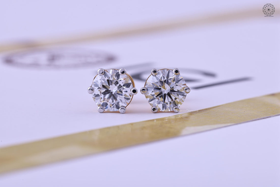 Round cut lab grown diamond stud earrings set in 14K gold with a solitaire design
