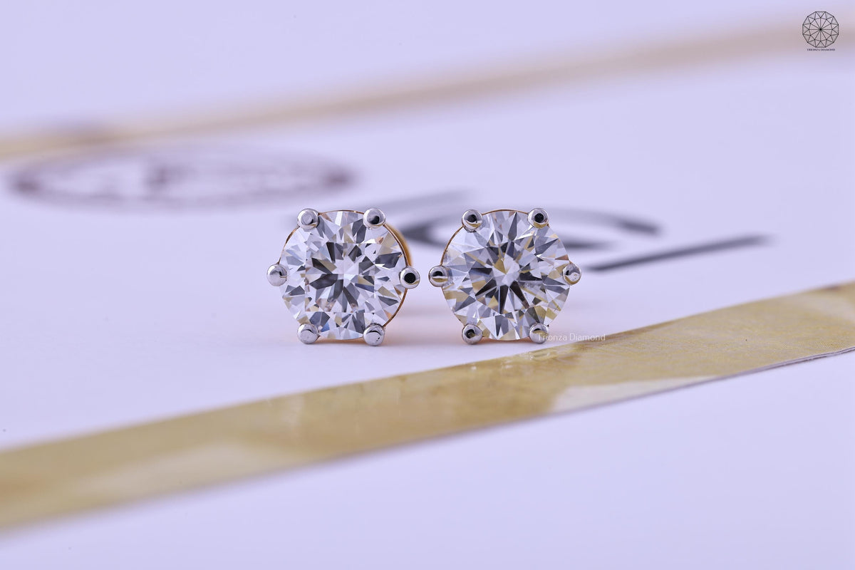 Round cut lab grown diamond stud earrings set in 14K gold with a solitaire design