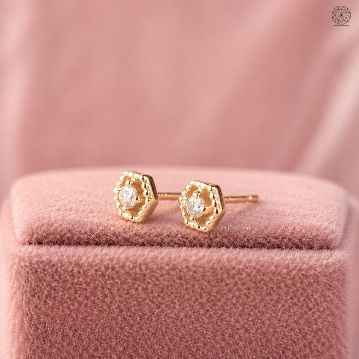 Close-up of the round cut diamond set in the antique style hexagon earring design