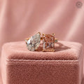 Pink radiant cut lab diamond toi et moi ring paired with a pear cut side stone in 14K gold