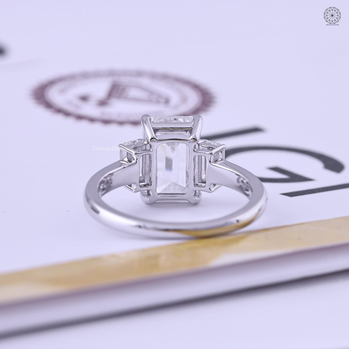 Emerald cut engagement ring displayed in its jewelry box with smooth fabric lining