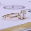 Emerald cut bridal ring presented in its jewelry box with smooth fabric lining