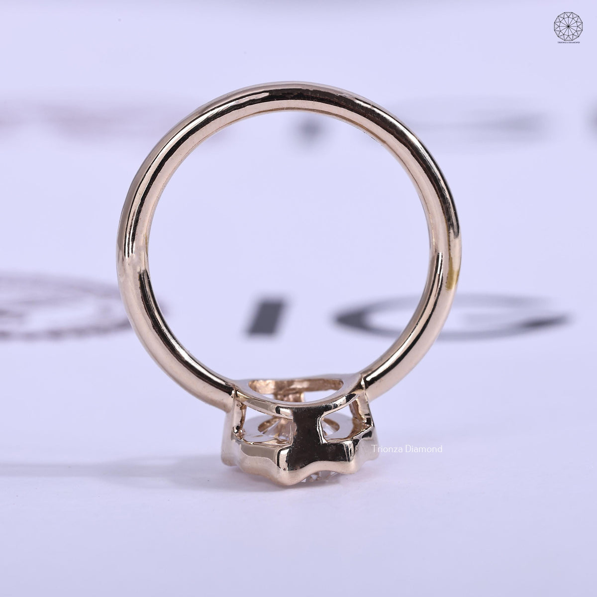 Side view of the abstract bezel solitaire ring highlighting the 14K gold setting