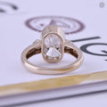 Solid 14k yellow gold engagement ring designed with a bezel set cushion diamond