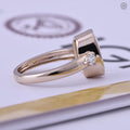 Ring displayed in its jewelry box alongside the smooth fabric included with purchase