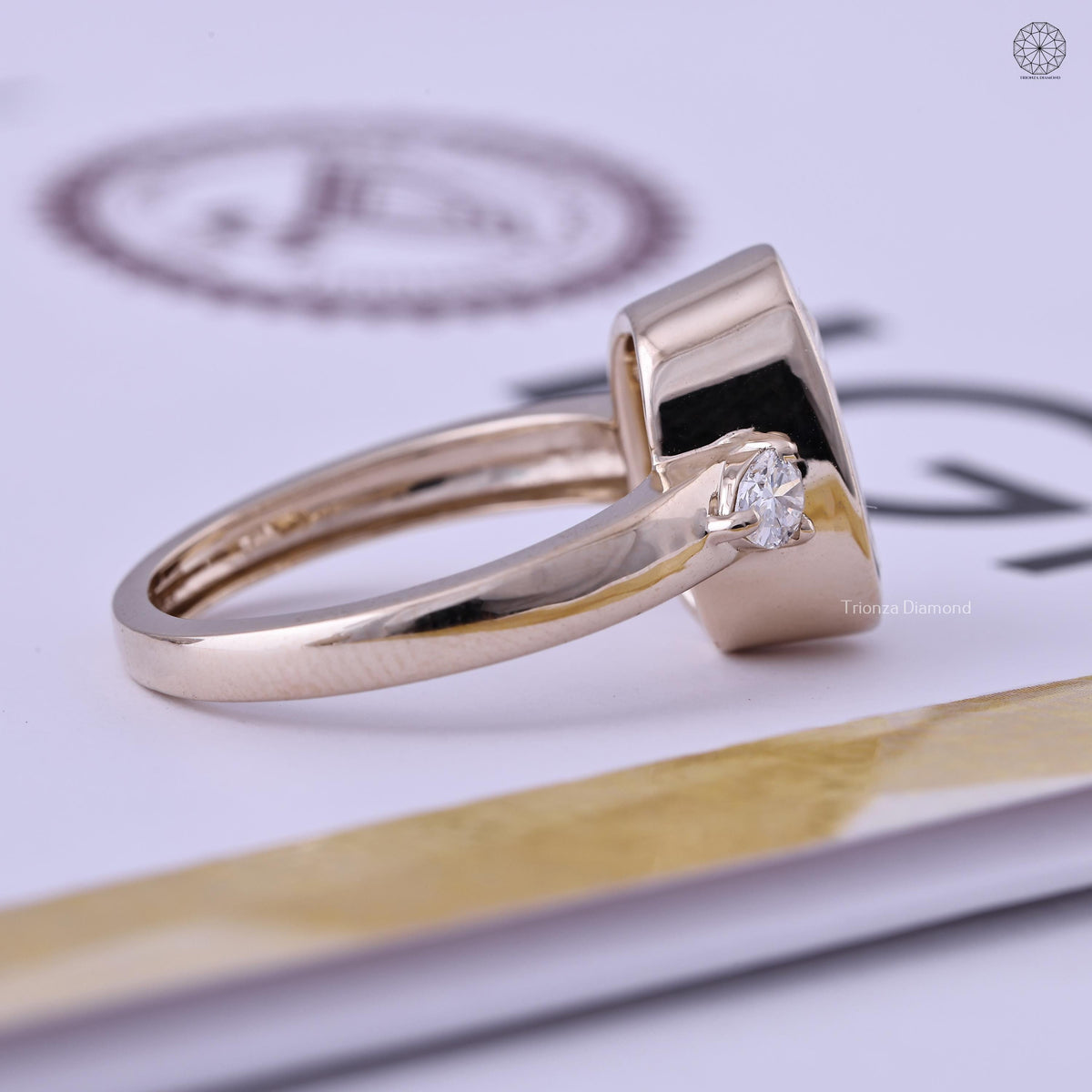 Ring displayed in its jewelry box alongside the smooth fabric included with purchase