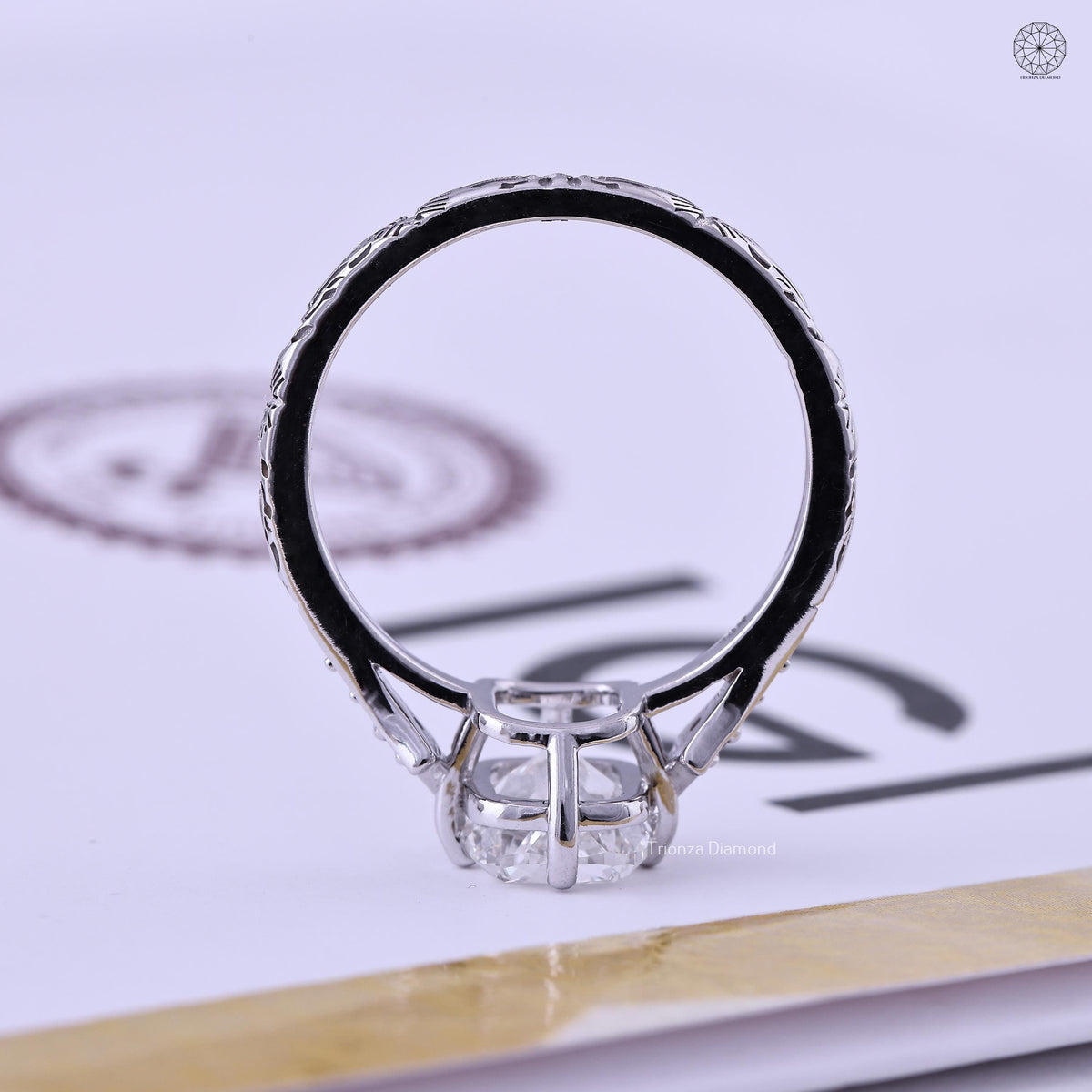 Close-up of the 3 CT cushion cut center stone set in a 4 prong setting